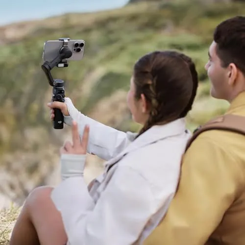 A couple capturing a selfie with a gimbal stabilizer