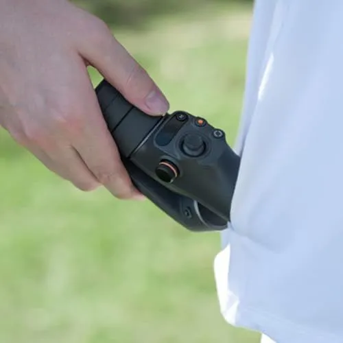 A Handheld Camera Stabilizer Held Near a Pocket