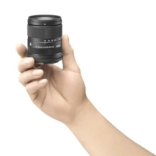 A handheld Sigma 18-50mm camera lens