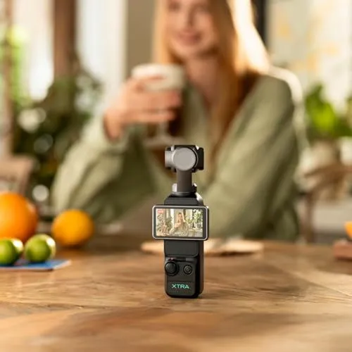 A portable gimbal camera capturing a scene on a wooden table