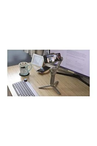 A smartphone gimbal stabilizer on a wooden desk