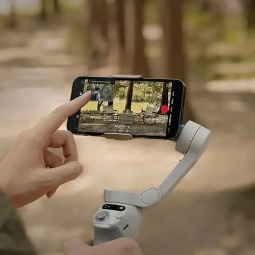 A smartphone mounted on a handheld gimbal stabilizer