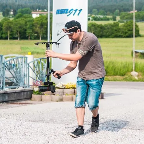 Filmmaker using a professional camera stabilizer outdoors