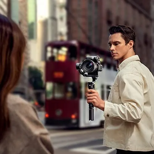 Man Operating Camera Stabilizer on City Street
